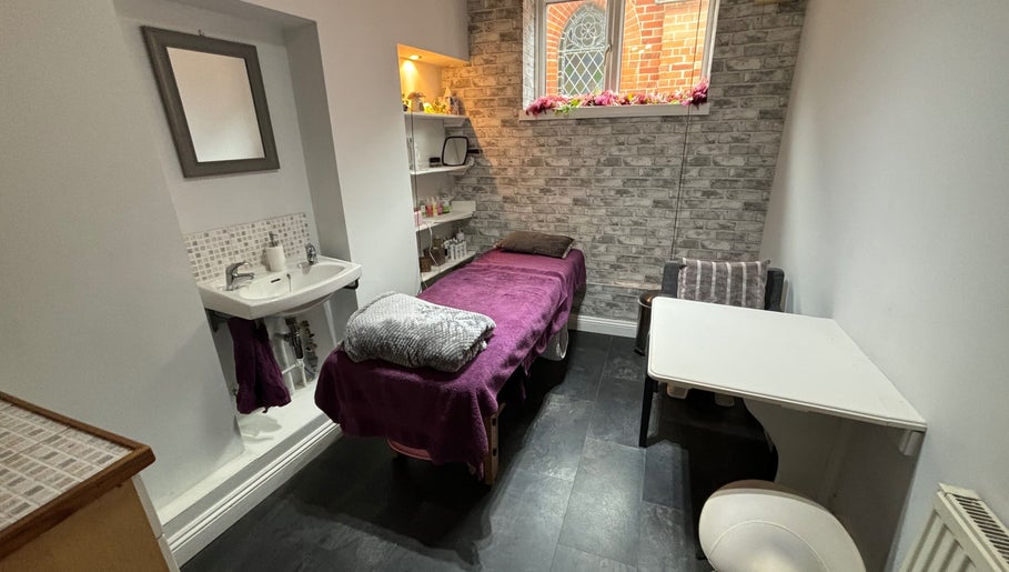 Beauty By Willow treatment room in Weymouth, England, GB featuring a cozy massage table and serene ambiance.