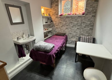 Beauty By Willow treatment room in Weymouth, England, GB featuring a cozy massage table and serene ambiance.