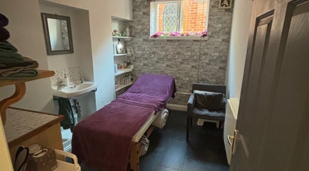 Calm treatment room with table and chair at Beauty By Willow, Weymouth, England, GB.