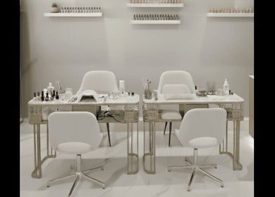 Chic nail salon setup at Beauty Essentials, Edinburgh, Scotland, GB, featuring modern white chairs and manicure tables.