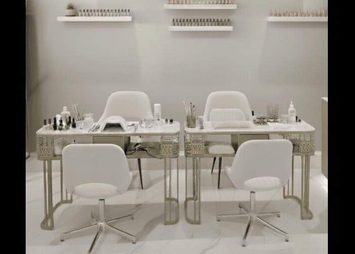 Chic nail salon setup at Beauty Essentials, Edinburgh, Scotland, GB, featuring modern white chairs and manicure tables.