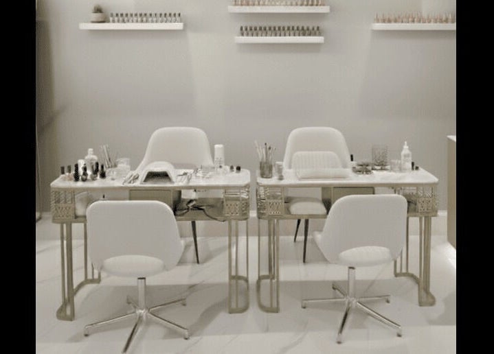 Chic nail salon setup at Beauty Essentials, Edinburgh, Scotland, GB, featuring modern white chairs and manicure tables.