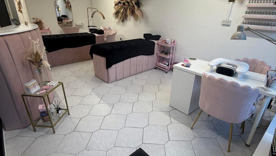 Elegant interior of Makeupbykc in Aberkenfig, Wales, GB, featuring plush pink seating and chic decor.