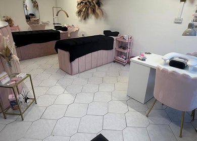 Elegant interior of Makeupbykc in Aberkenfig, Wales, GB, featuring plush pink seating and chic decor.