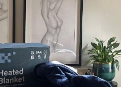 Carly Whitington London wellness center with a heated blanket, artwork, and plant on display.