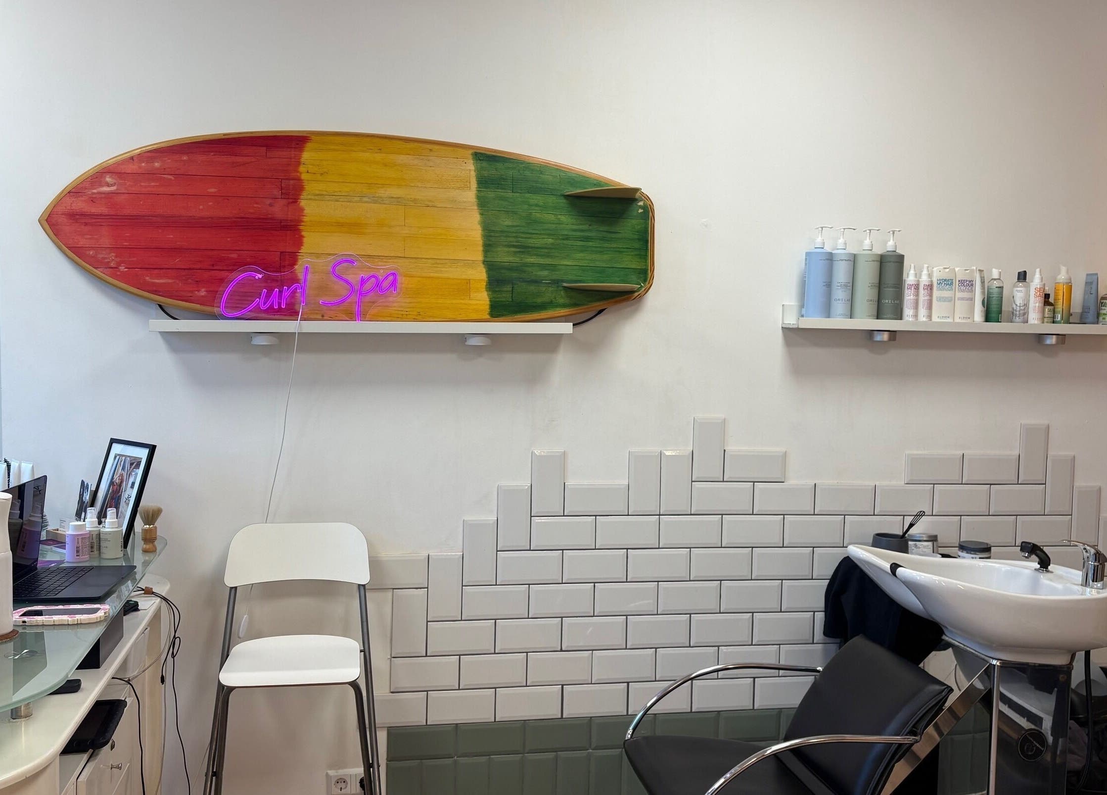 Cozy interior of Curl Spa Salon The Hague, Den Haag, Zuid-holland, NL with vibrant surfboard wall decor.