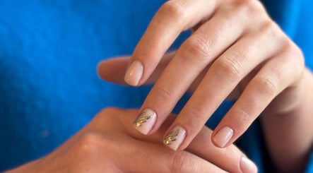 Manucure artistique chez Maeva Paillettes, Hénin-Beaumont, Hauts-de-France, FR. Ongles élégants avec motifs dorés.