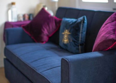 Luxurious blue sofa with velvet cushions in THE TEMPLE ROOM, Minster On Sea, England, GB.