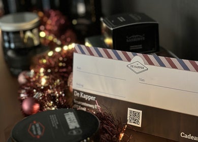 Cadeaubon van De Kapper Elewijt, gelegen in Zemst, Vlaanderen, BE, versierd met feestelijke accenten.