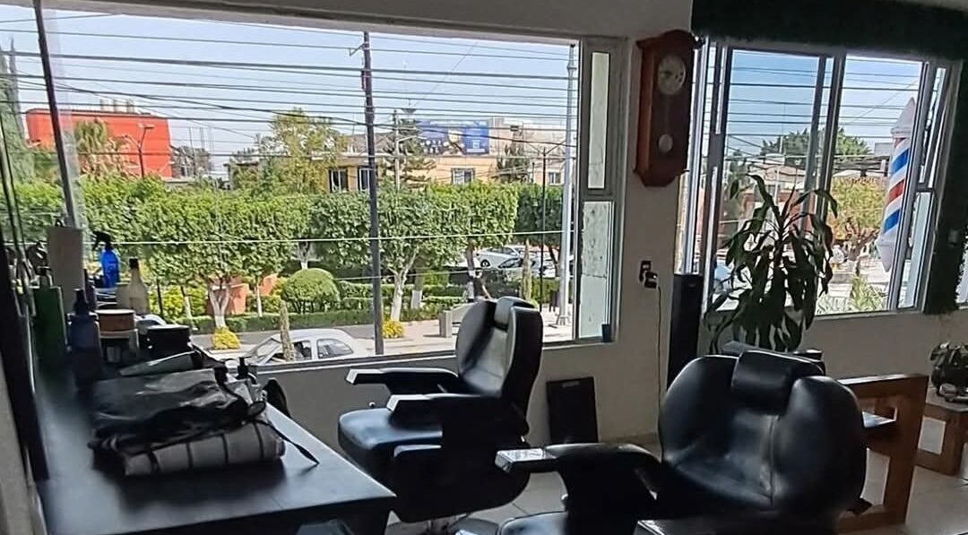 Interior de Hair cuts studio en Pedro Escobedo, Querétaro, MX con sillas de peluquería y vista exterior.