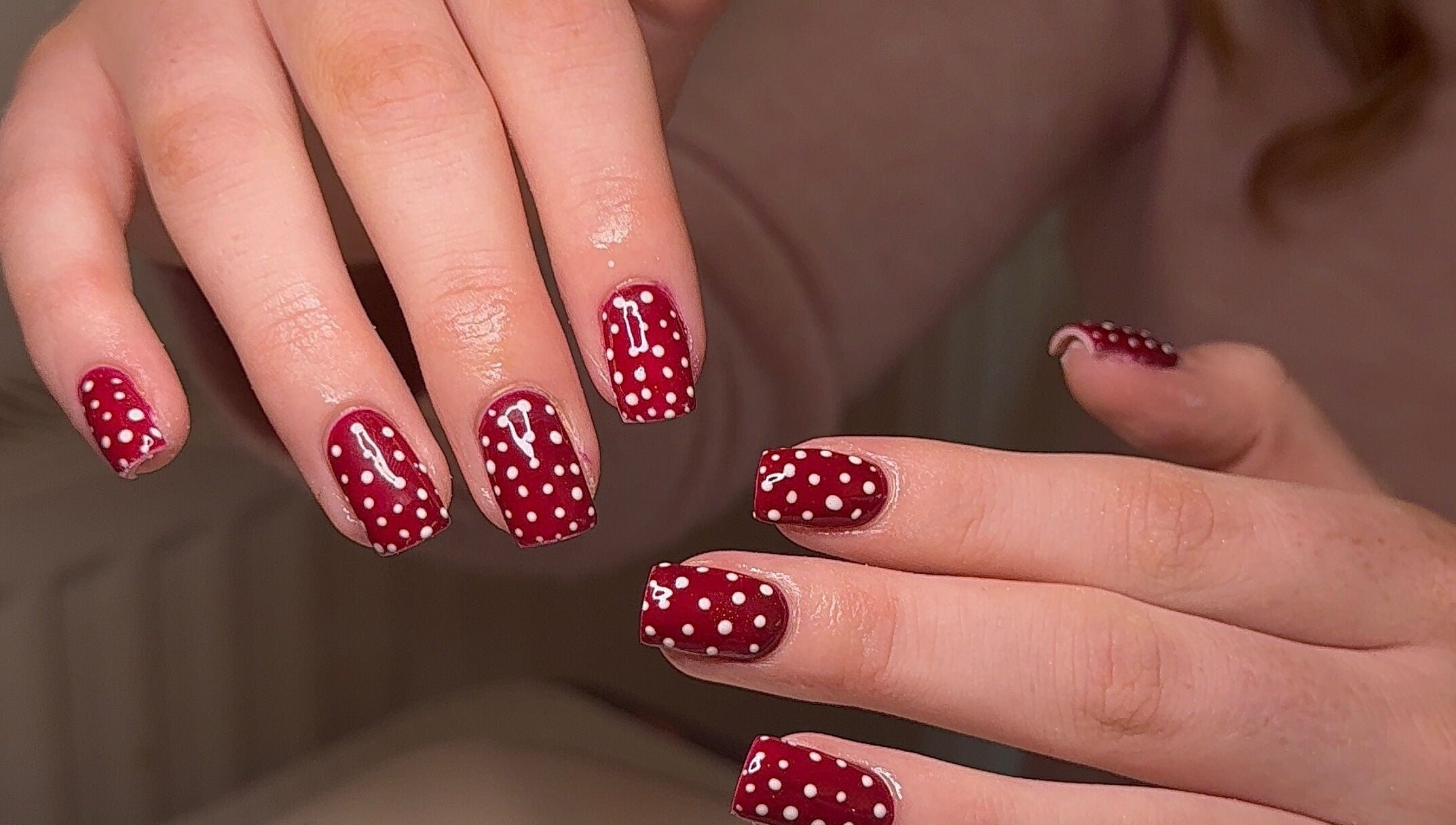 Red polka dot nail art at BySorayah, Birmingham, England, GB showcasing creative manicure design.