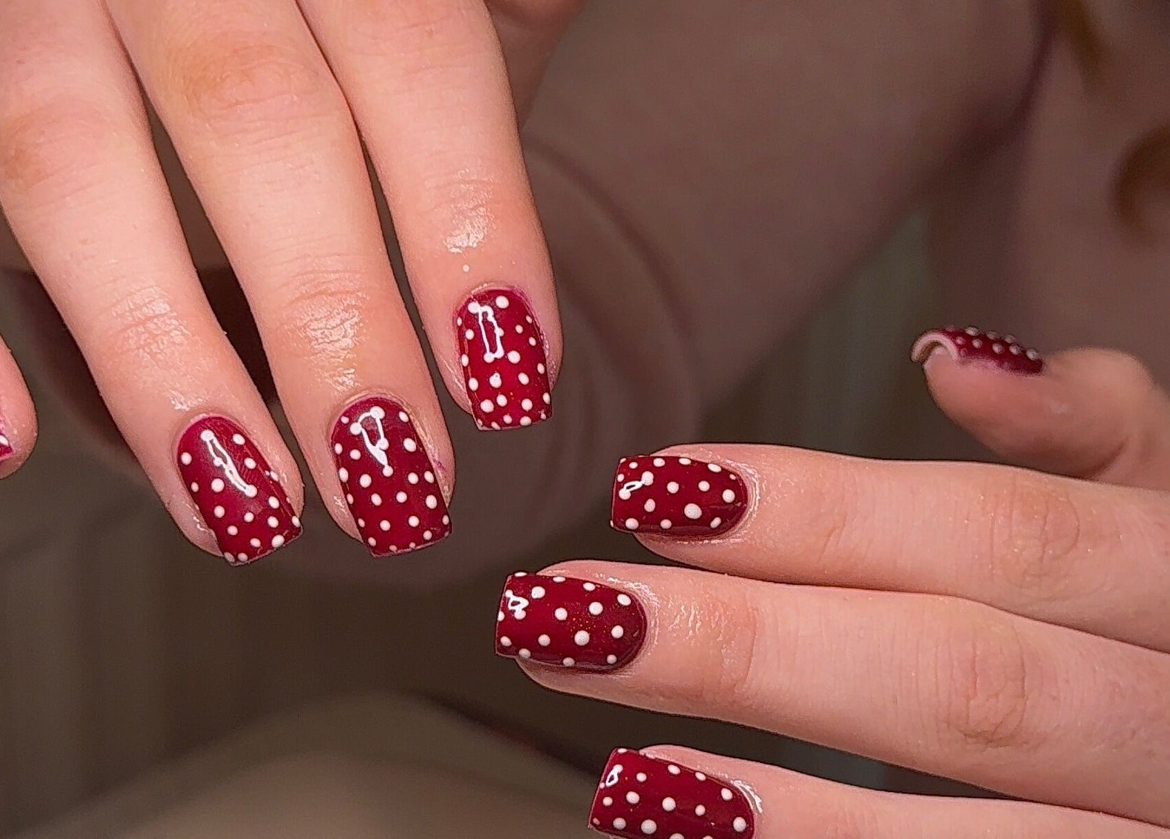 Red polka dot nail art at BySorayah, Birmingham, England, GB showcasing creative manicure design.