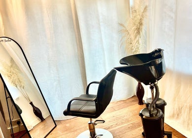 Modern salon setup at Sleek Hair By C, Poole, England, GB featuring sleek styling chair and wash basin.