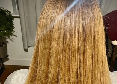 Sleek Hair By C in Poole, England, GB showcases smooth, shiny straight hair in a modern salon setting.