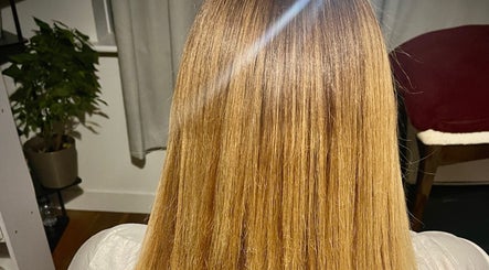 Sleek Hair By C in Poole, England, GB showcases smooth, shiny straight hair in a modern salon setting.