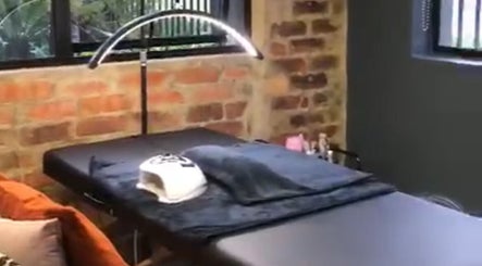Cozy treatment room at The Sonho Beauty Studio in Centurion, Gauteng, ZA, featuring a massage bed and soft lighting.