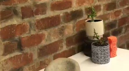 Brick wall with potted plants at The Sonho Beauty Studio, Centurion, Gauteng, ZA.