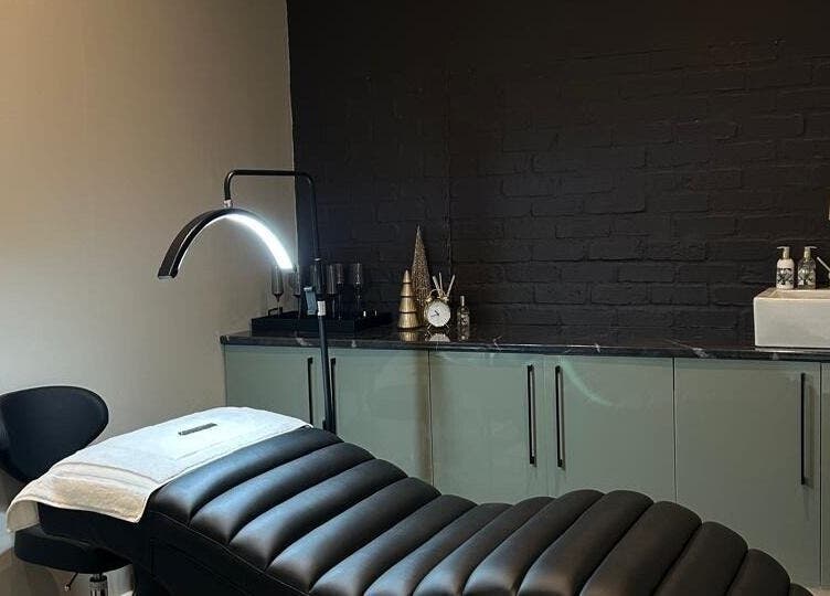 Relaxing treatment room at Ion Beauty and Makeup, Paarl, Western Cape, ZA with a black bed and modern decor.