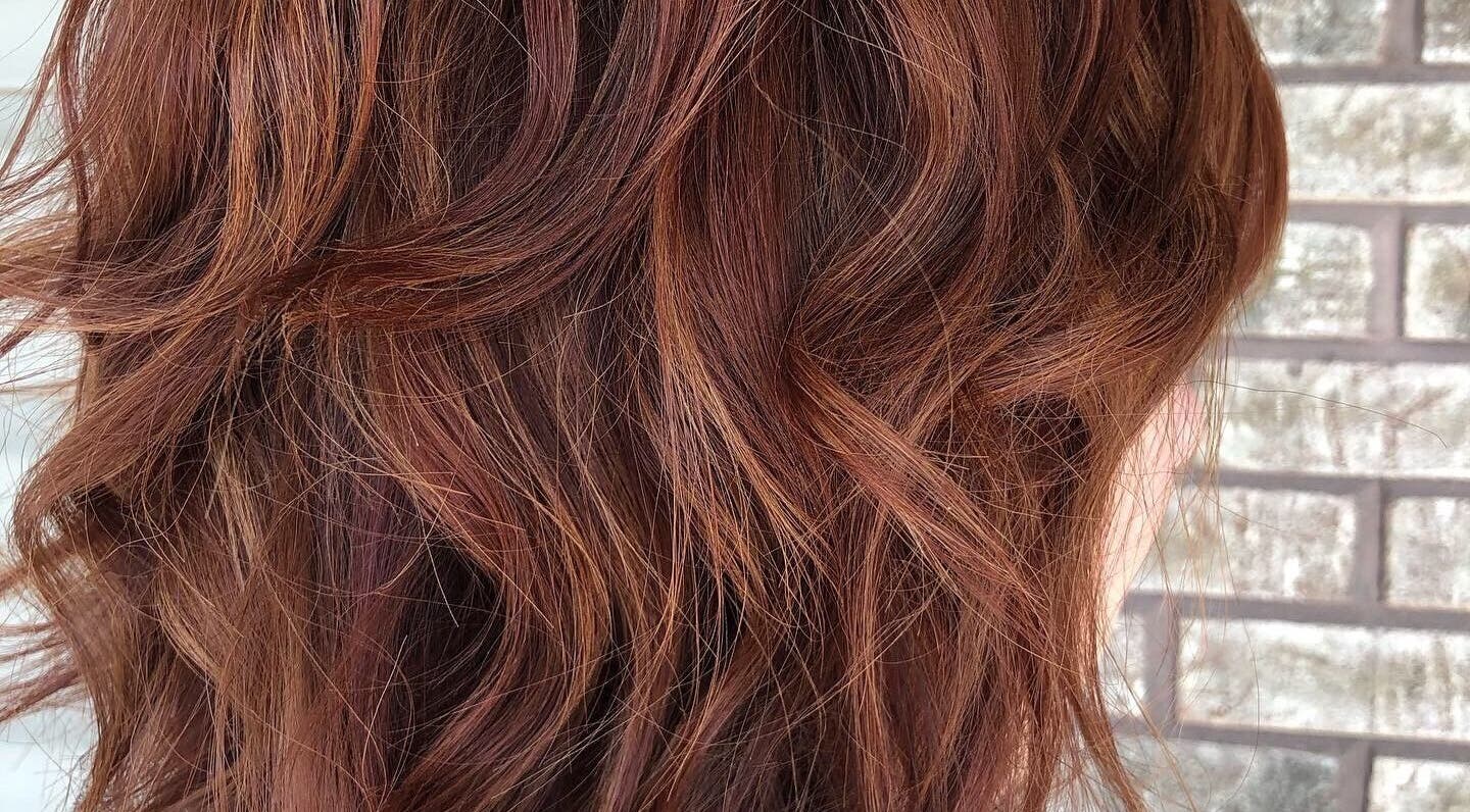 Voluminous copper waves styled at Hair Shack, Bourbon, Missouri, US enhance the beauty of this hairstyle.
