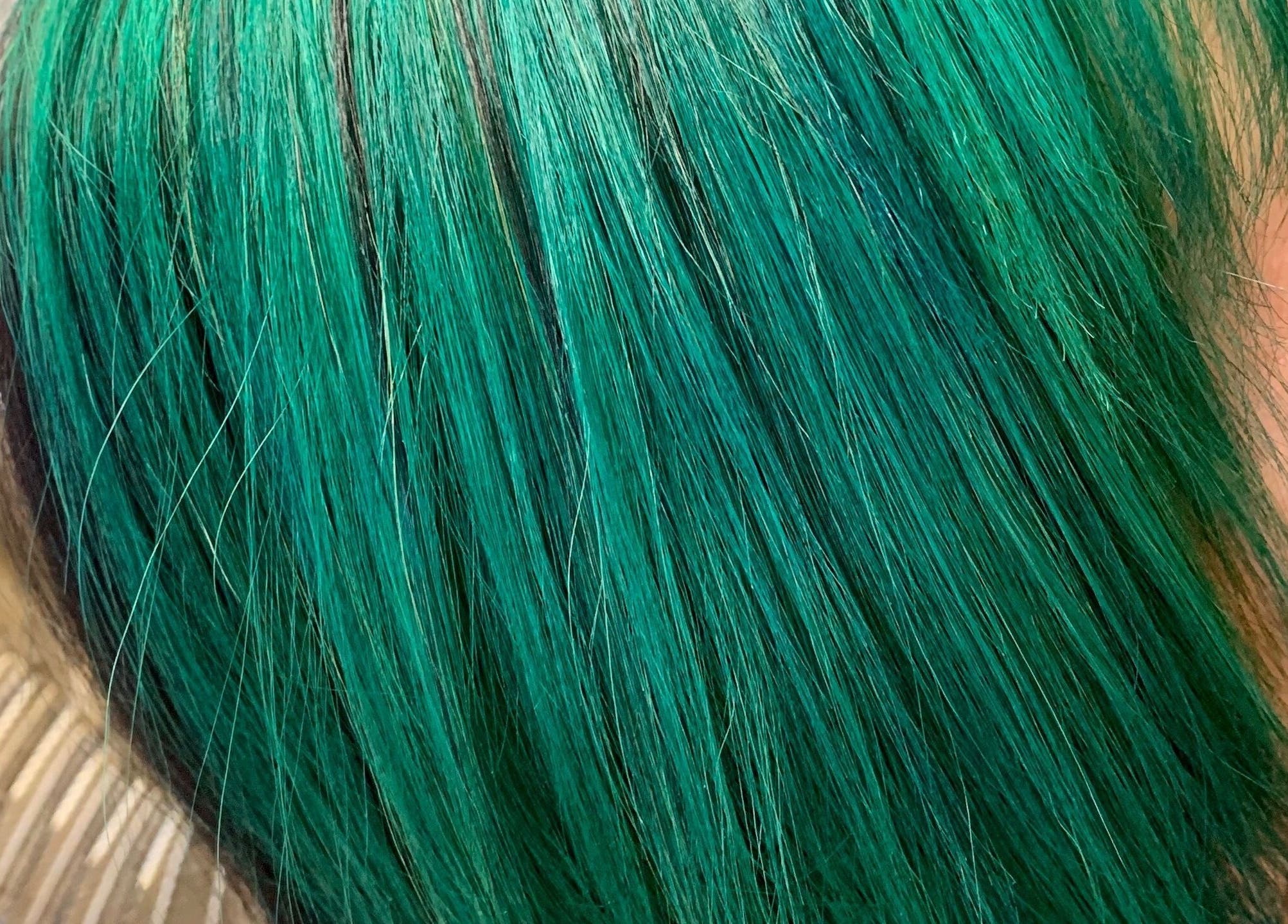 Vibrant emerald hair styled at Hair Shack, Bourbon, Missouri, US.