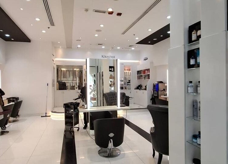 Bright interior of Laurance Beauty Salon in Dubai, AE showing modern chairs and product displays.