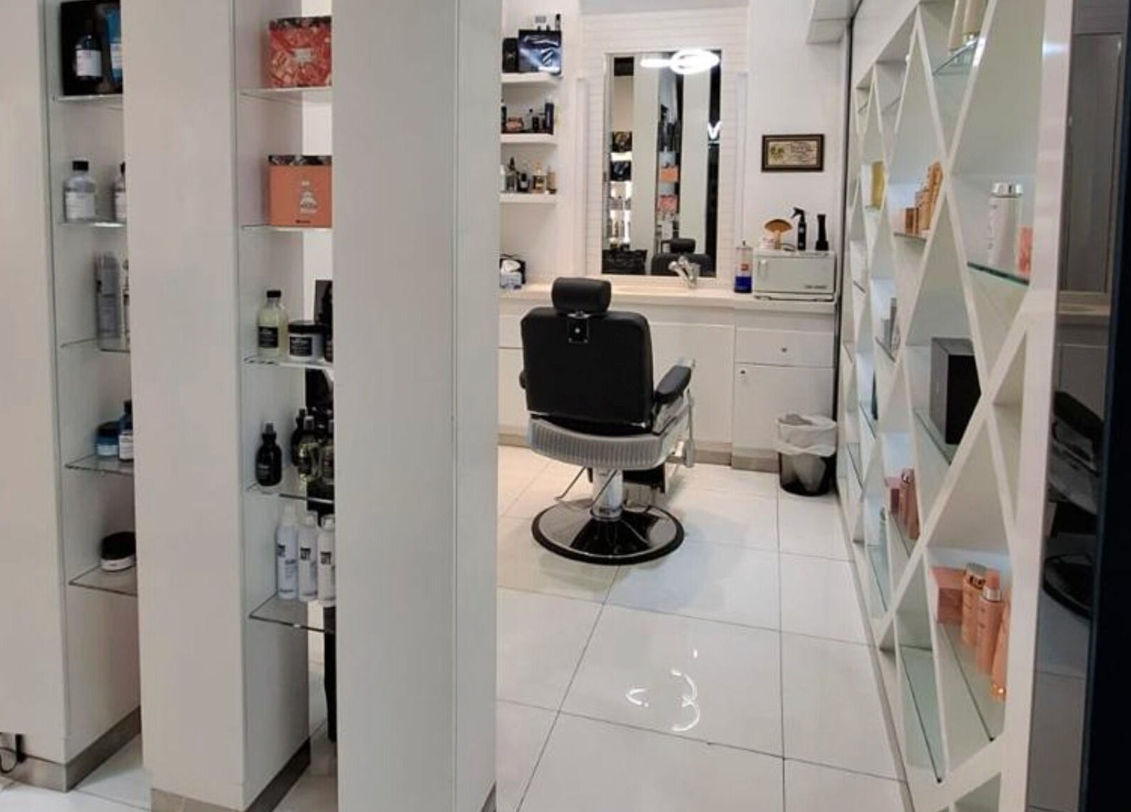 Modern interior of Laurance Beauty Salon in Dubai, AE showcases sleek decor and plush styling chair.