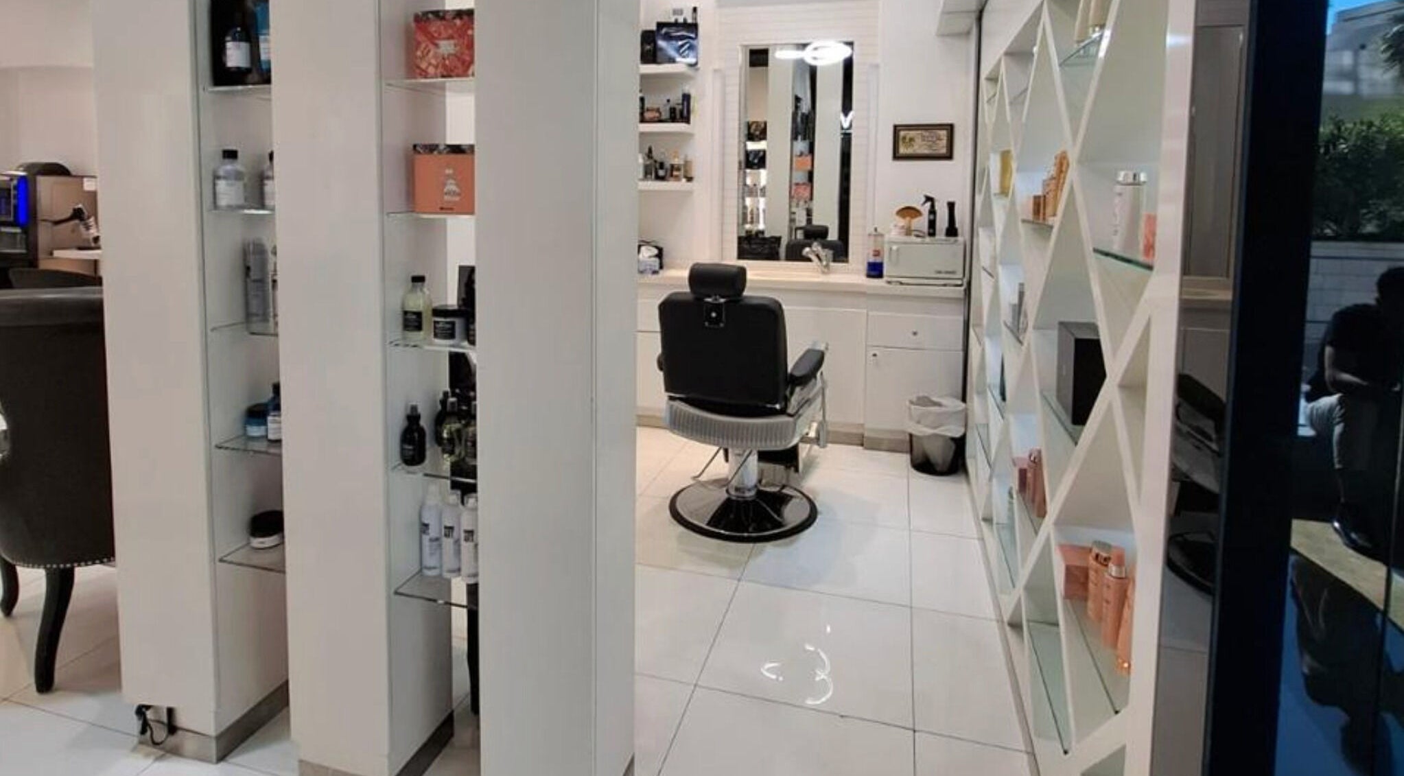Modern interior of Laurance Beauty Salon in Dubai, AE showcases sleek decor and plush styling chair.