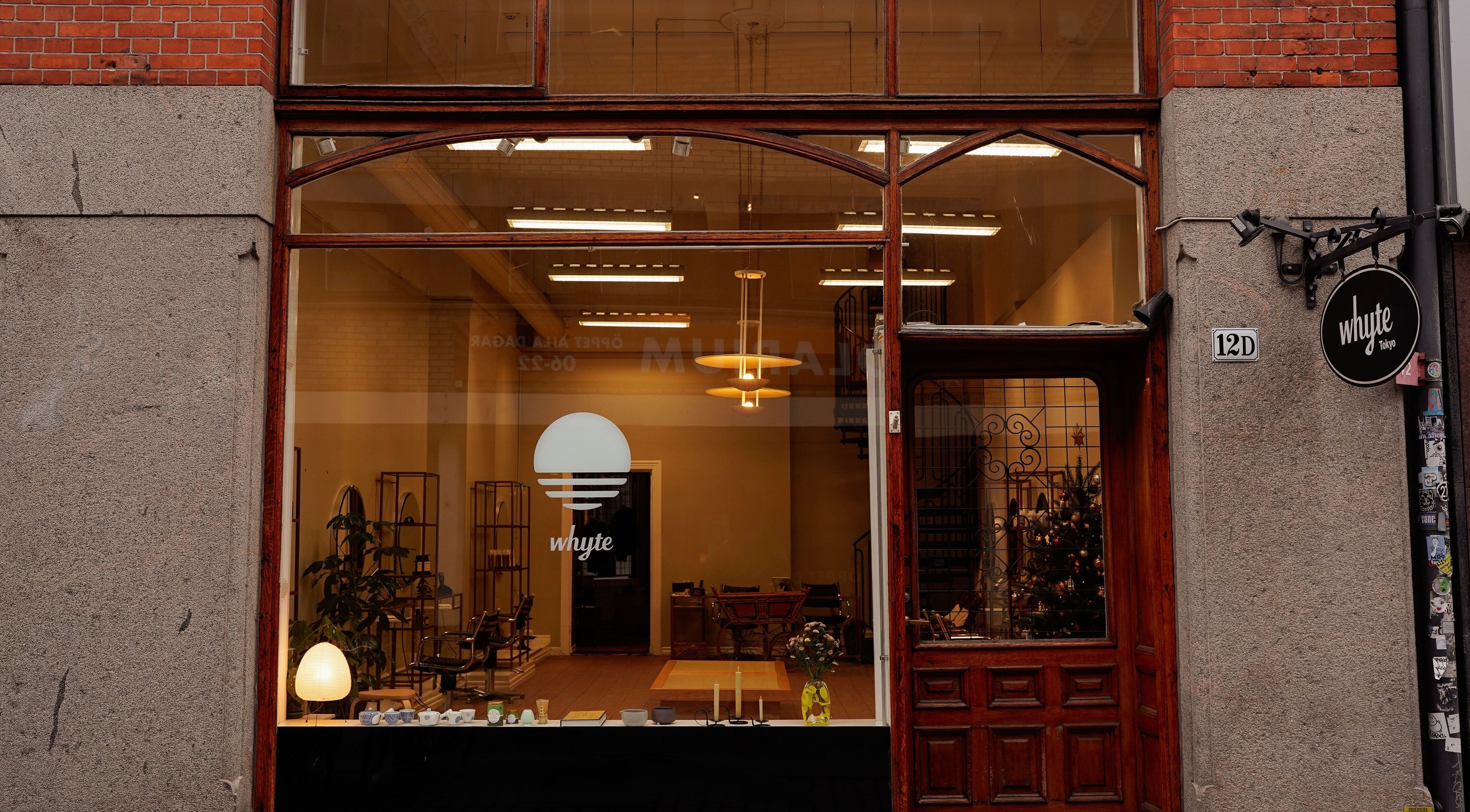 Entrance of Whyte salon in Malmö, Skåne Län, SE showcasing a chic interior through large windows.