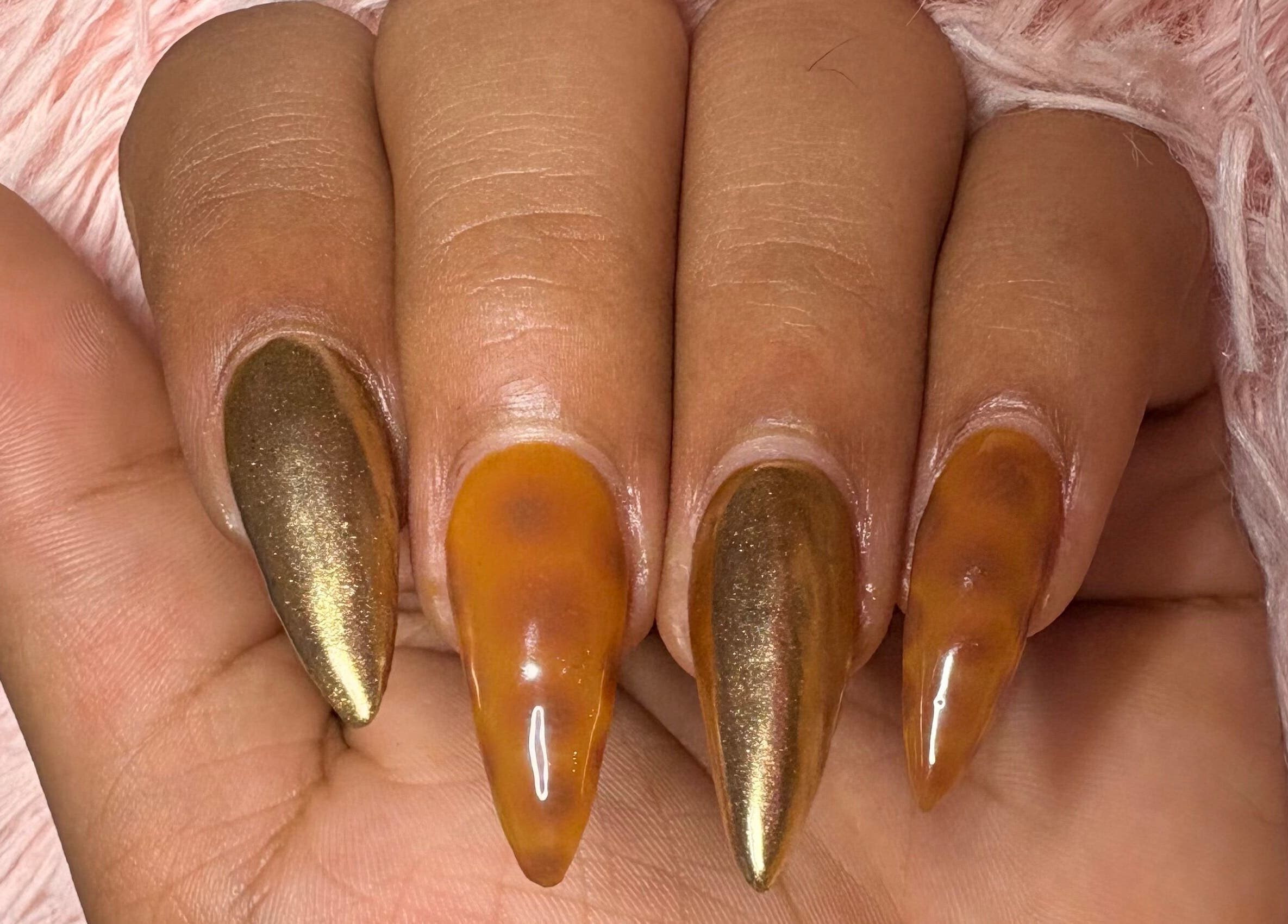 Stunning metallic and amber nail art at The Claw Club in Prince Edward, Ontario, CA.