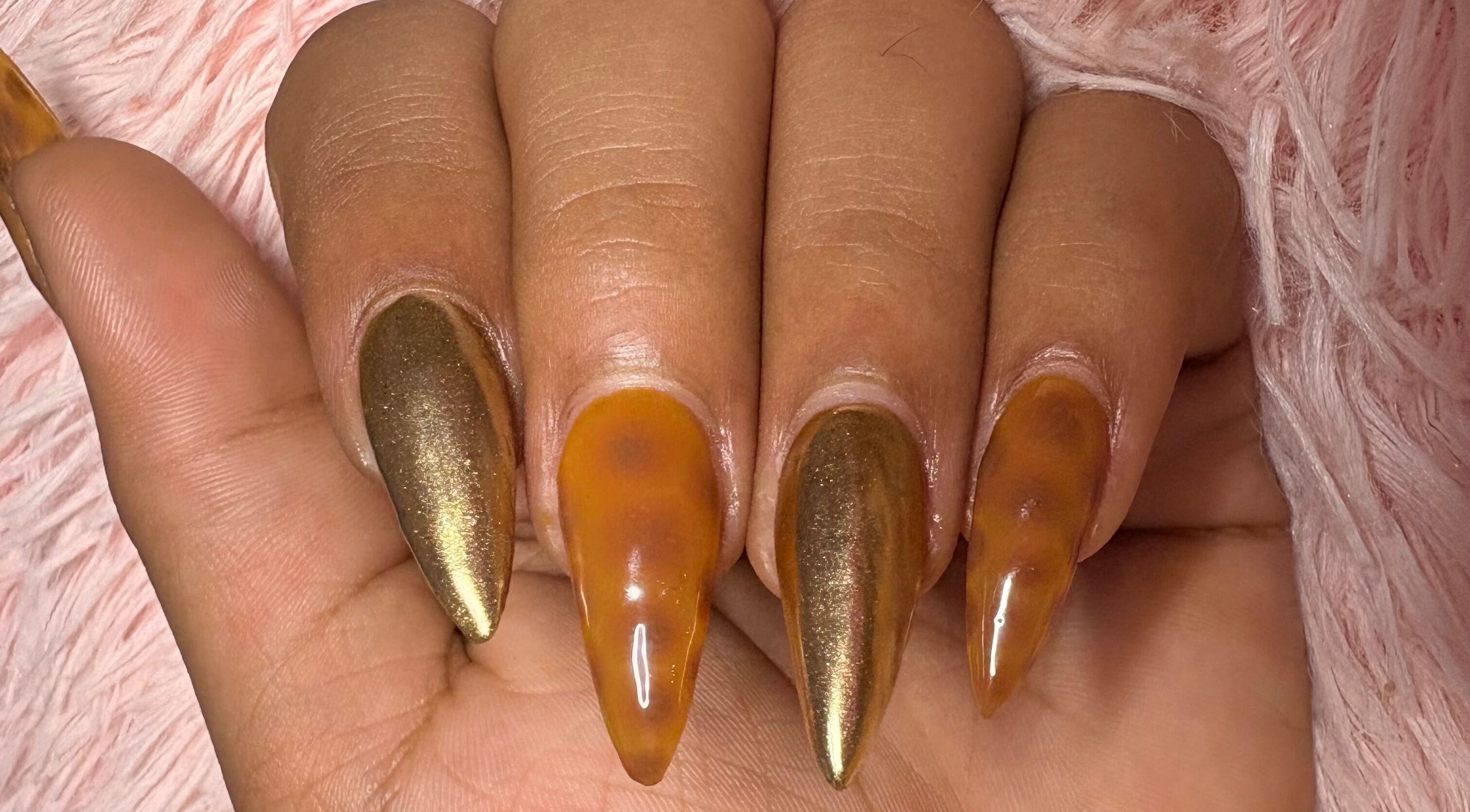 Stunning metallic and amber nail art at The Claw Club in Prince Edward, Ontario, CA.