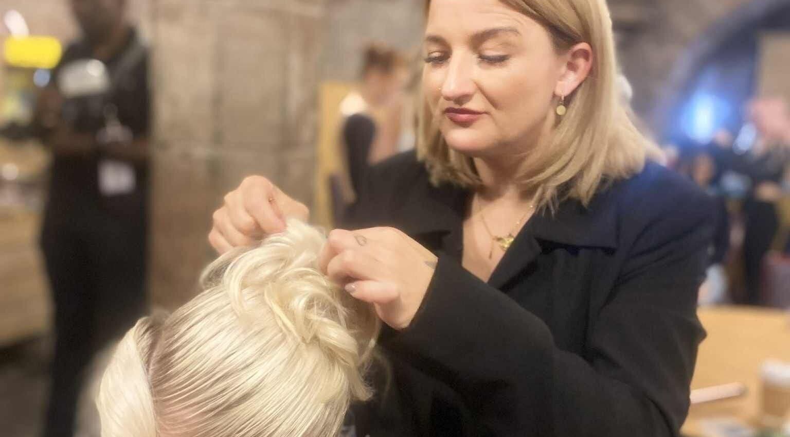 Justyna Gierej perfecting an elegant hairstyle at Royton, Lancashire, GB beauty venue.