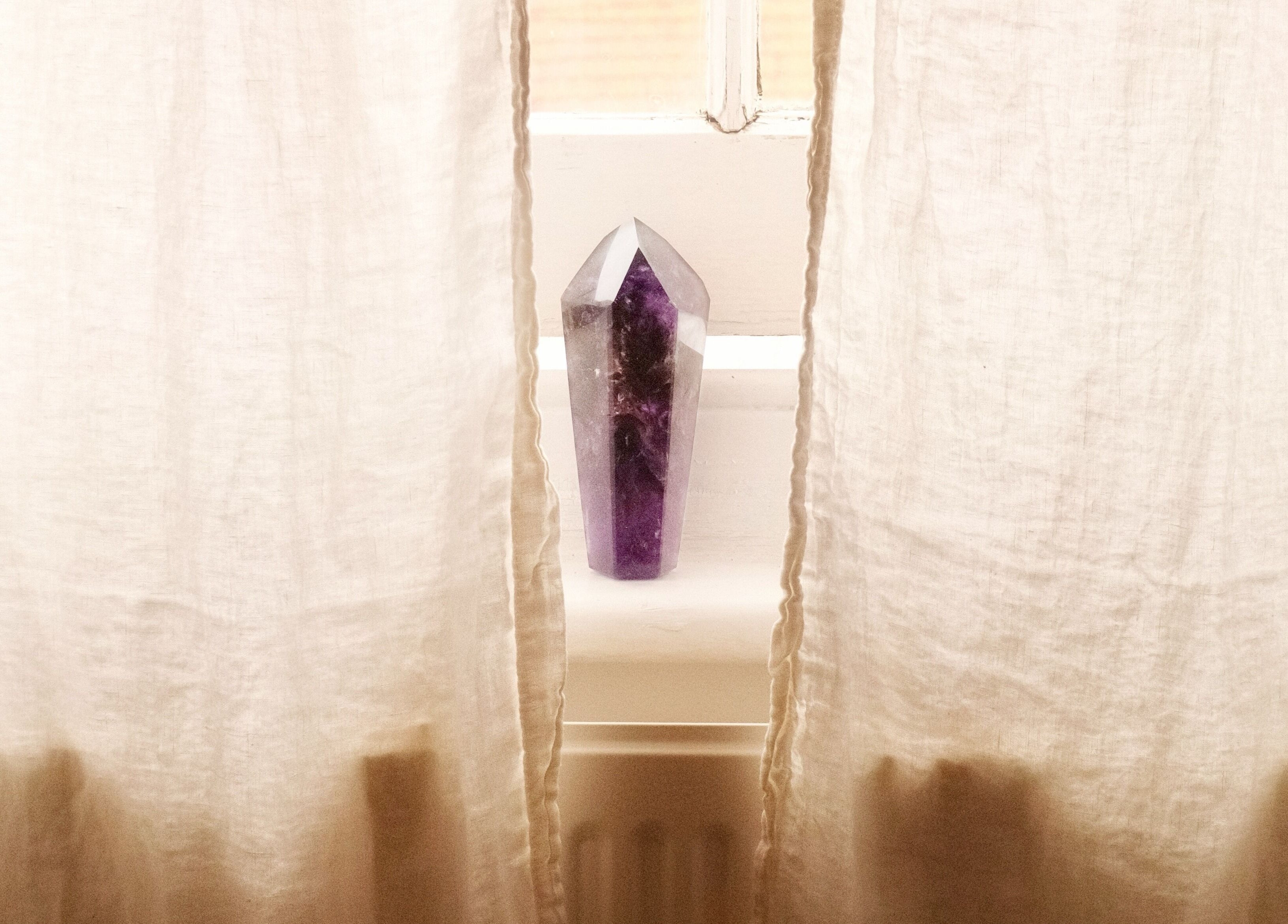 Amethyst crystal on windowsill at Spell Holistic in Saint Leonards, England, GB, creating a serene ambiance.