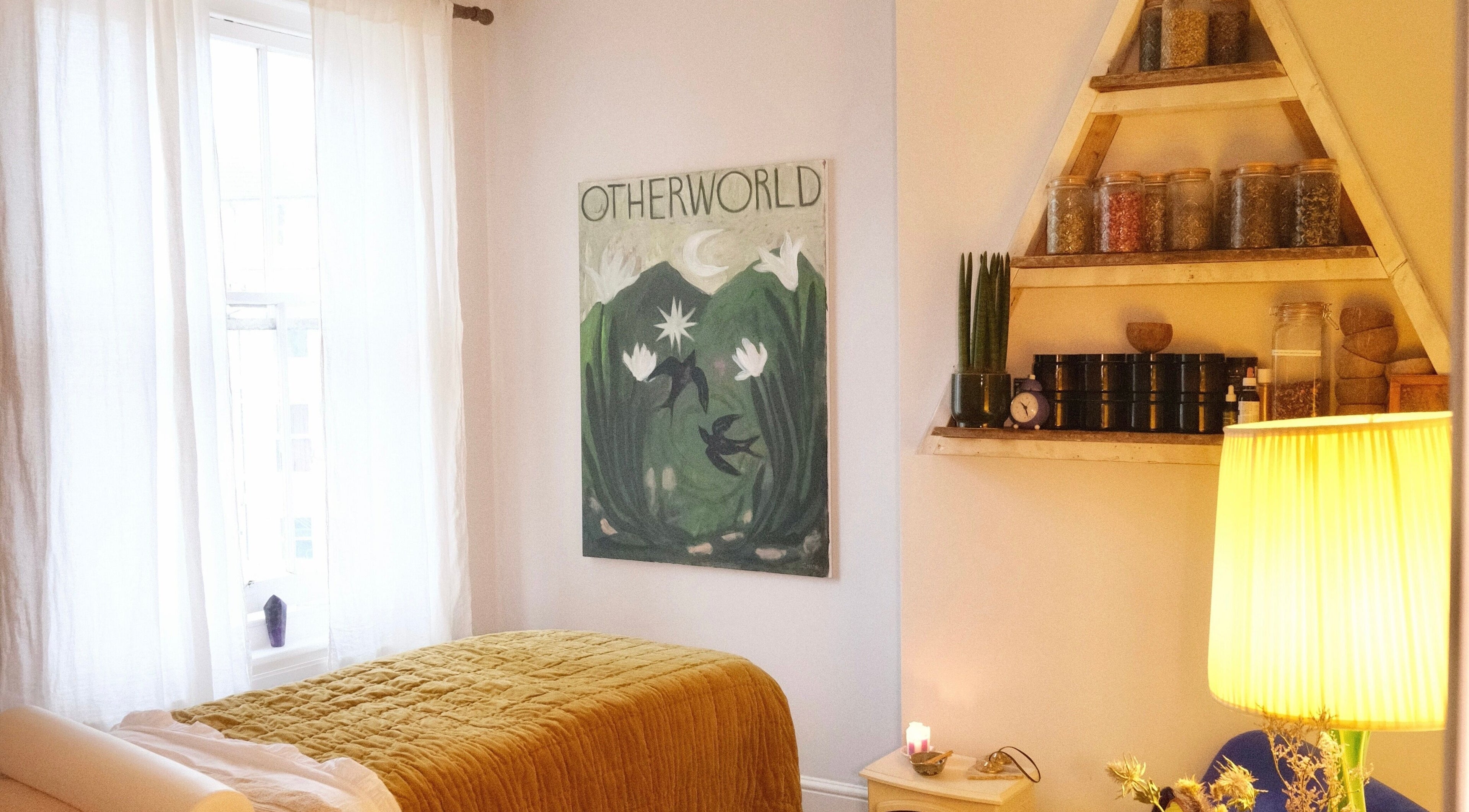 Cozy therapy room at Spell Holistic, Saint Leonards, England, GB featuring a bed, art, and soothing decor.