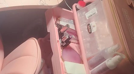 The Nail Crypt's pink manicure station in Thunder Bay, Ontario, CA showcasing nail polishes and tools.