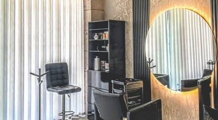 Chic salon setup at Sandra Trejos Marin, Melbourne, Victoria, AU with modern chair and round mirror.