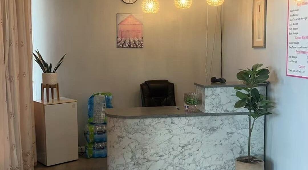 Reception area at A Relax Massage in Macon, Georgia, US with a marble desk and warm lighting.