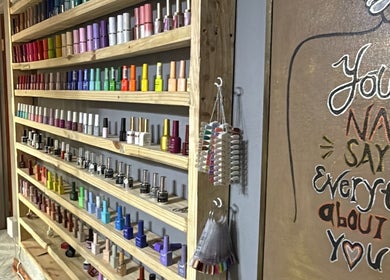 Colorful nail polish display at Taylored Nails, Mbombela, Mpumalanga, ZA, showcasing extensive selection.