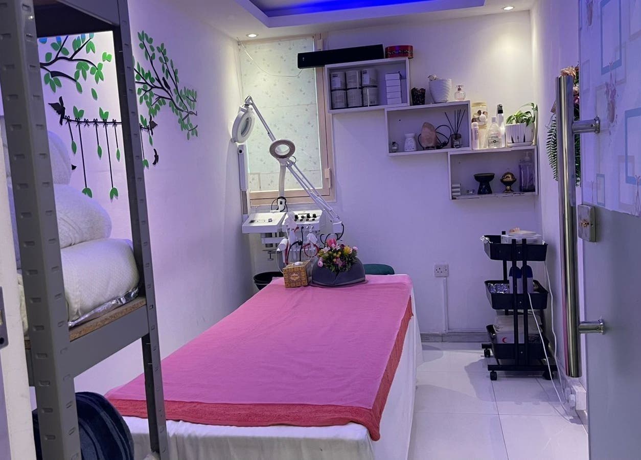 Tranquil treatment room at Beauty Garden Lady Salon, Abu Dhabi, AE, featuring a pink-covered massage table.