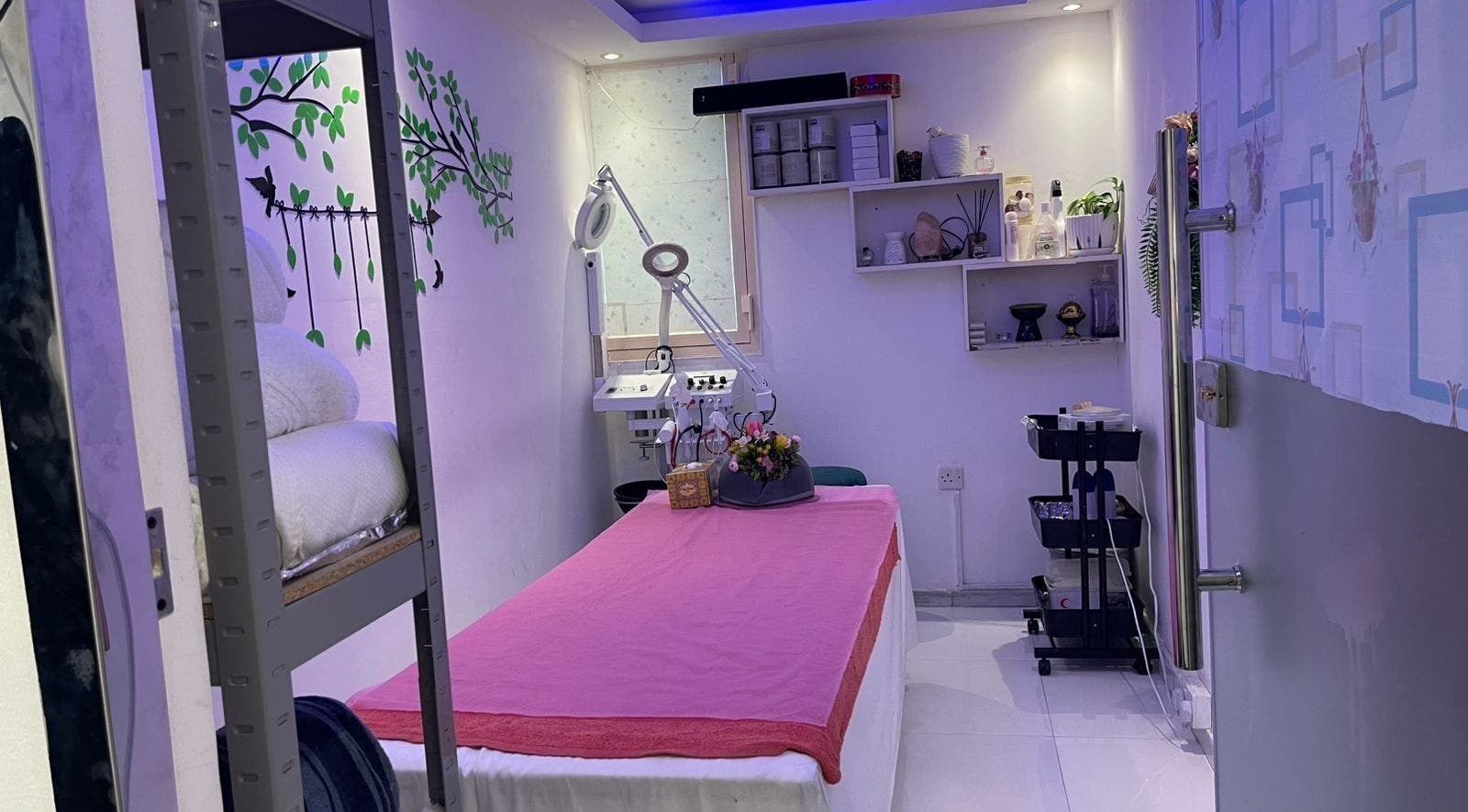 Tranquil treatment room at Beauty Garden Lady Salon, Abu Dhabi, AE, featuring a pink-covered massage table.