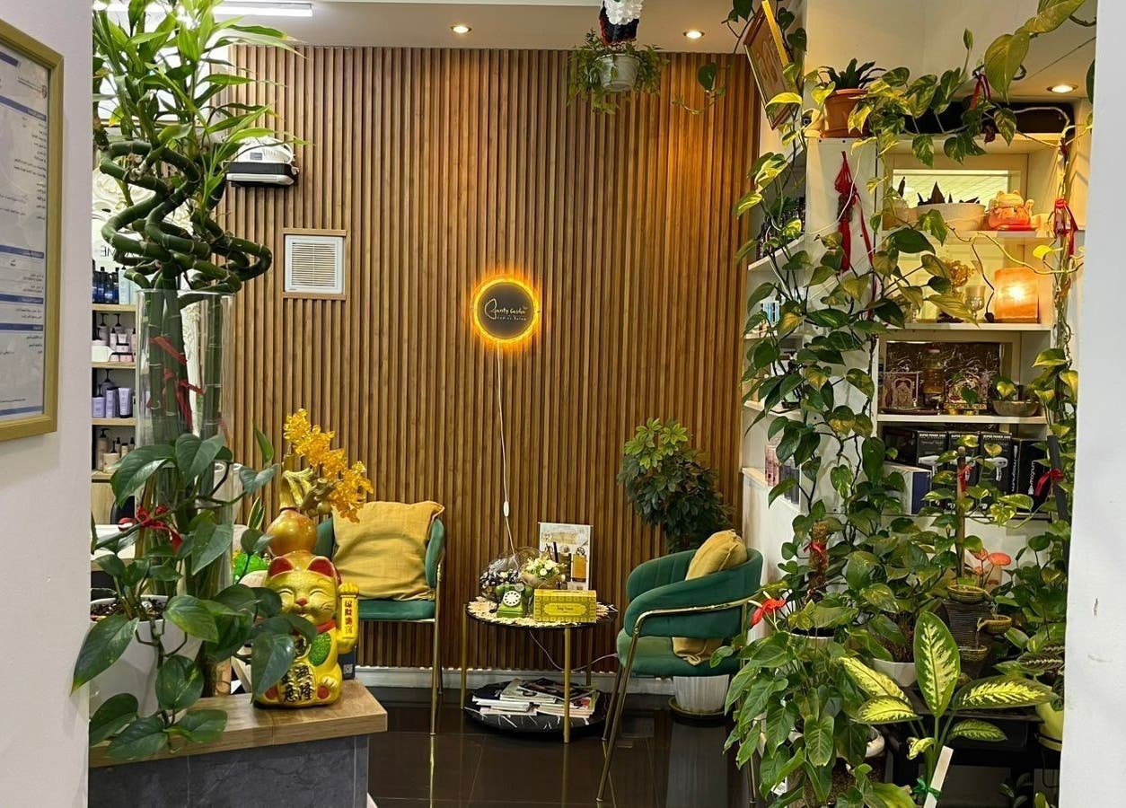 Cozy seating area at Beauty Garden Lady Salon in Abu Dhabi, AE, surrounded by lush plants and warm lighting.