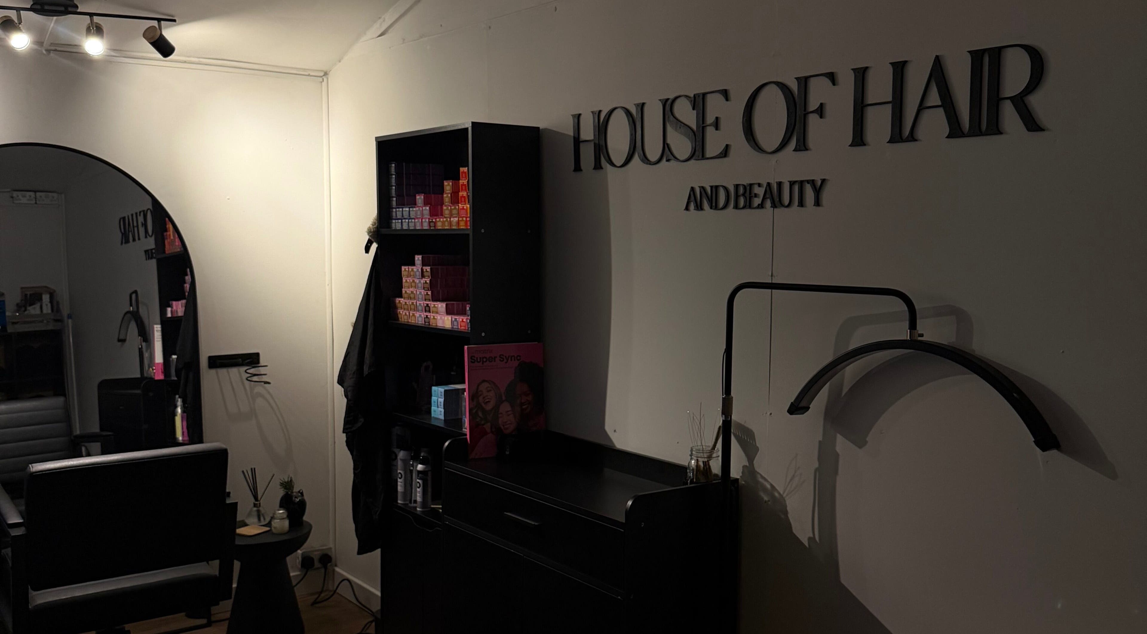Interior of The House Of Hair & Beauty in Wolverhampton, England, showing stylish salon setup and product shelves.