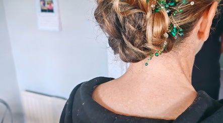 Intricate hair updo with green accents at Faces of Angels, Hartlepool, England, GB.