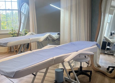 Calming treatment room at Rebecca Slane Skin, Alderley Edge, England, GB. Featuring spa beds and mirrors.