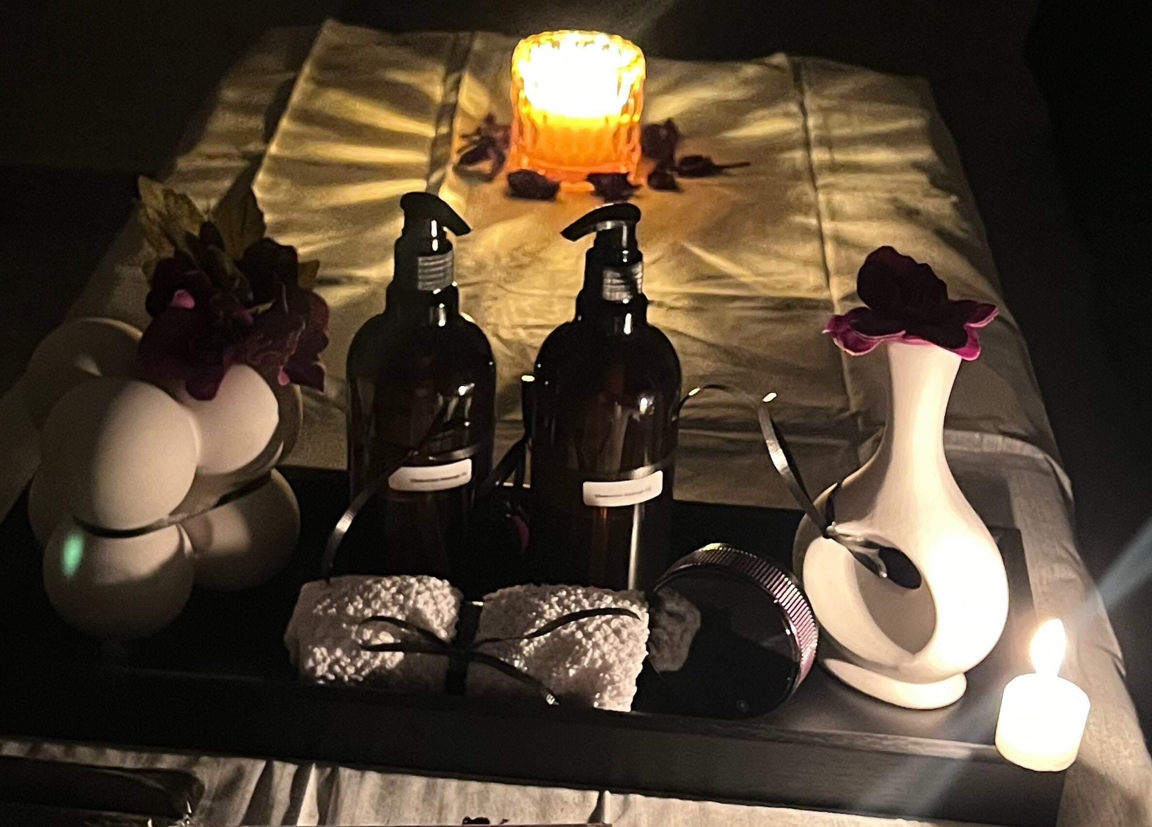 Candlelit relaxation setup at Glamorous Salon جلامورس صالون in Riyadh, SA, featuring oils and decor.