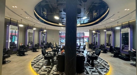 Spacious interior of Al Alami Barbershop العالمي, Jeddah, Makkah Province, SA featuring chic styling stations.