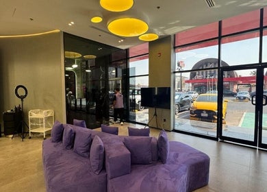 Contemporary seating area with purple sofa at Al Alami Barbershop العالمي, Jeddah, Makkah Province, SA.