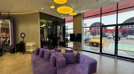 Contemporary seating area with purple sofa at Al Alami Barbershop العالمي, Jeddah, Makkah Province, SA.