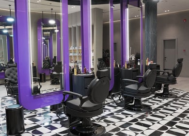 Modern interior of Al Alami Barbershop العالمي in Jeddah, Makkah Province, SA featuring stylish barber chairs.