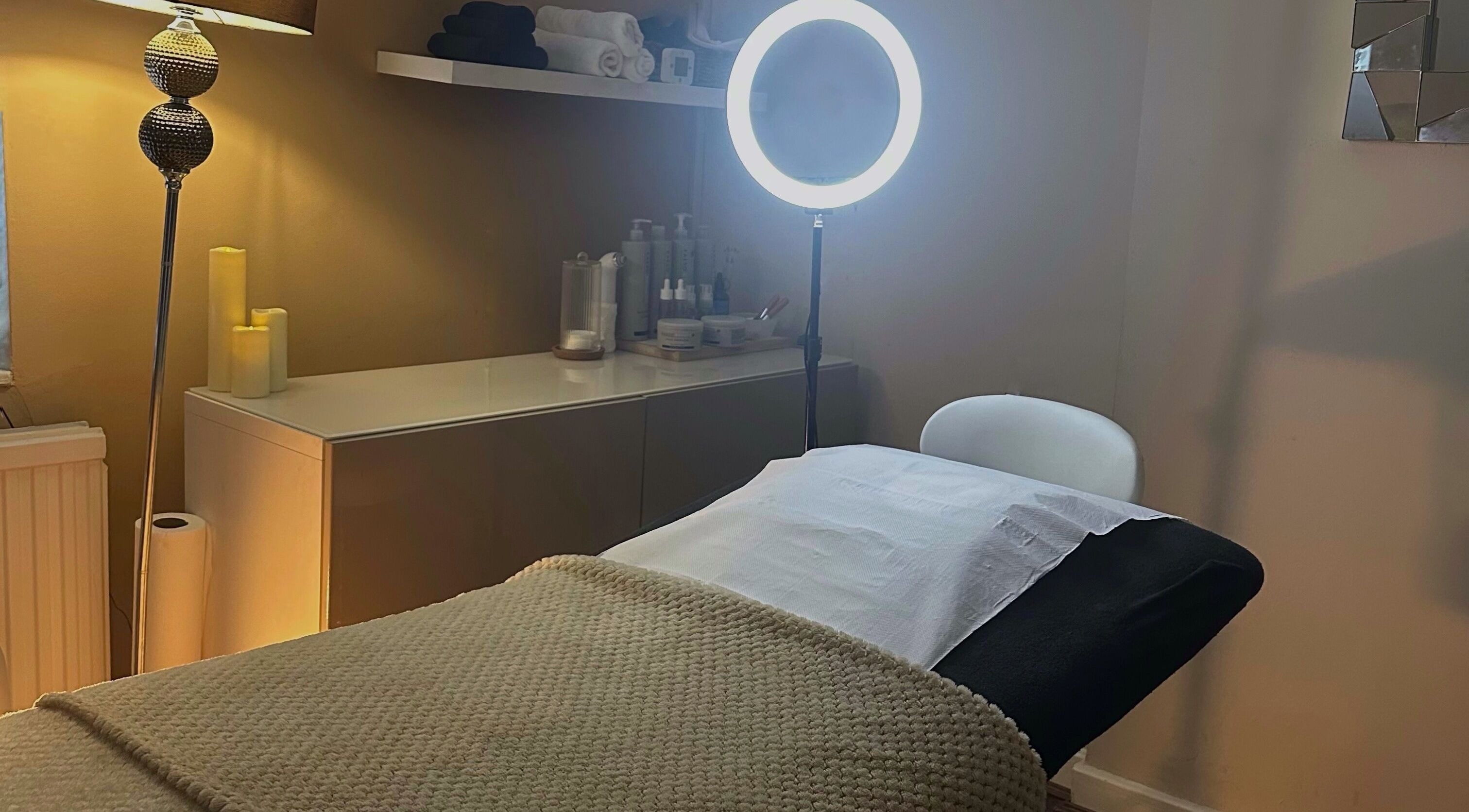 Peaceful therapy room at Beautt, Leicester, England, GB, featuring a treatment bed and ambient lighting.