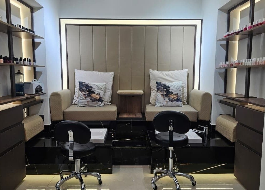 Luxurious nail service area at Mia Dolce Beauty Salon, Dubai, Dubai, AE, with chic seating and nail polish display.